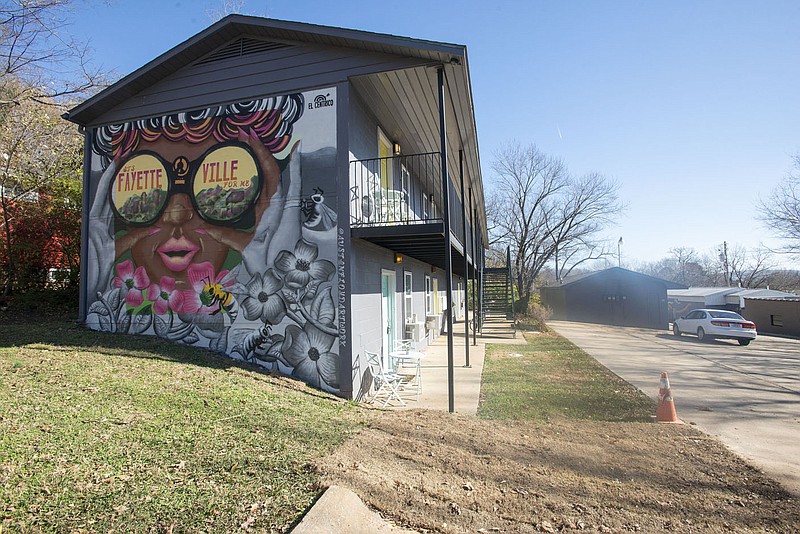 A mural, seen here Wednesday Dec. 8, 2021, titled, 'It's Fayetteville for Me,' painted this year by artist Austin Floyd adorns a wall of an apartment complex on South Church Avenue in Fayetteville. The city plans to put more than $219,000 in the budget next year to create an arts and culture program, which will involve hiring a director of arts and culture and contracting with Creative Arkansas Community Hub and Exchange on collaborative planning of art. (NWA Democrat-Gazette/J.T. Wampler)