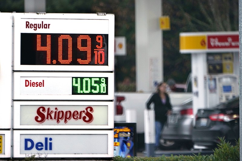 FILE - A driver fills a tank at a gas station Friday, Dec. 10, 2021, in Marysville, Wash.  Consumer prices rose 6.8% for the 12 months ending in November, a 39-year high. Many economists expect inflation to remain near this level a few more months but to then moderate through 2022 for a variety of reasons. And they don't see a repeat of the 1970s or early 1980s, when inflation ran above 10% for frighteningly long stretches.  (AP Photo/Elaine Thompson, File)