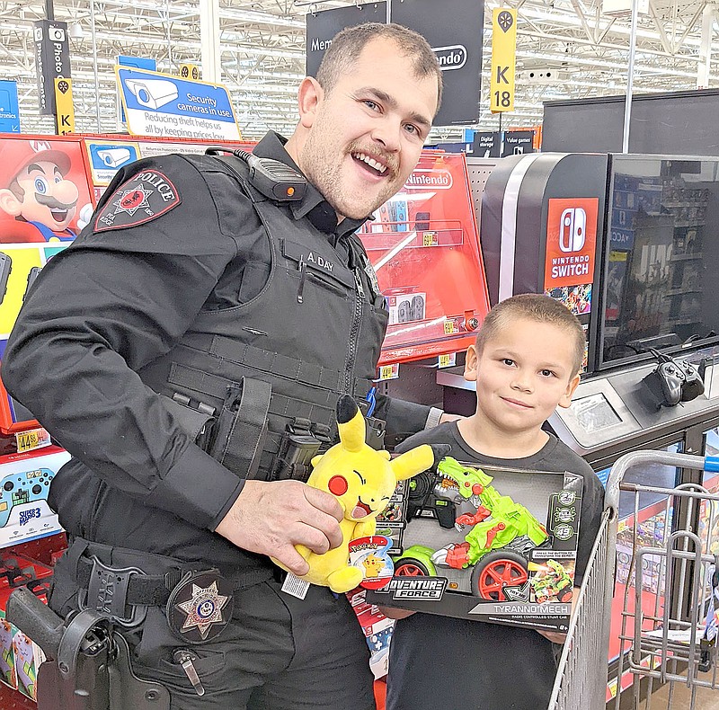 Pea Ridge Police Officer Andrew Day and a Pea Ridge student had fun shopping for Christmas gifts for the boy to give to family members and for himself during the Shop with a Cop event Friday, Dec. 10.