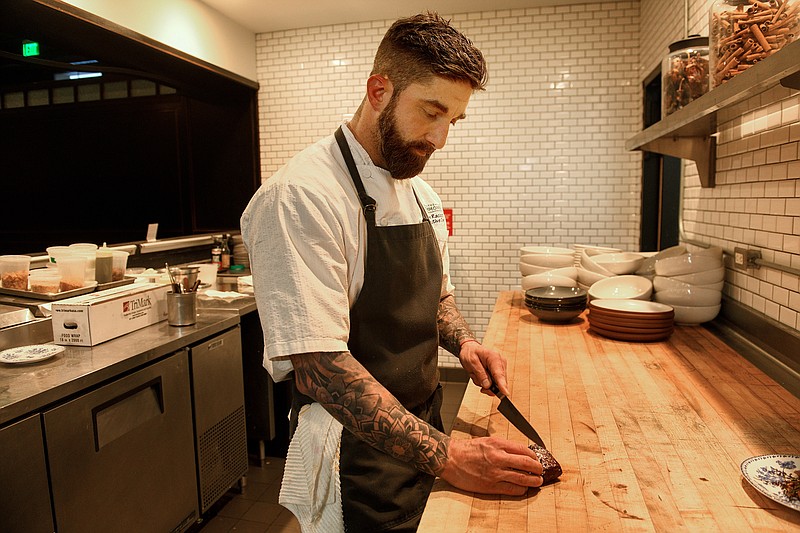 Dave Racicot, executive chef at The Commoner restaurant in Hotel Monaco in Pittsburgh, slices venison on Tuesday, Nov. 30, 2021. (Steve Mellon/Pittsburgh Post-Gazette/TNS)