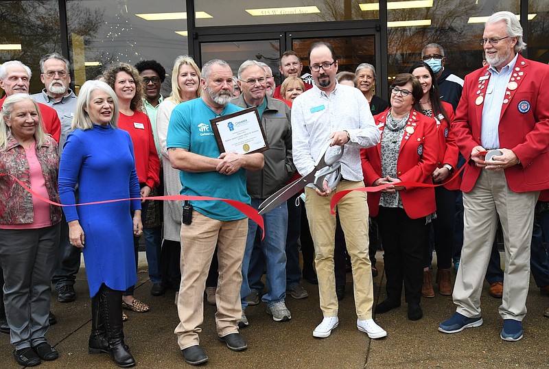 Romeo Lopez, ReStore manager, cuts the ribbon at the grand opening of the new location in November. - Photo by Tanner Newton of The Sentinel-Record