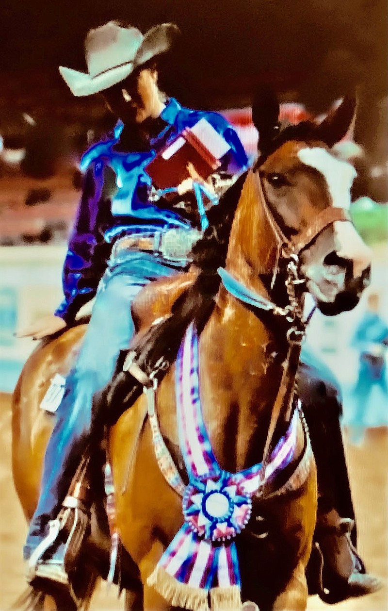 Submitted Photo
Landyn Kash Perrine gives her mount, 2005 mare Harlans Baldy Jo, an appreciative pat after competition at the 2021 American Quarter Horse Association Youth World in Oklahoma City. Baldy Jo carried Perrine to a prize winning performance in level one pole bending with a time of 20.785.