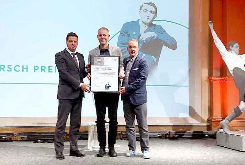 Photo Submitted JBU professor. Dr. Kevin Simpson (center), is presented the Julius Hirsch Honorary Prize along with his colleague Michal Vanek Ph.D. by the German Football Association. Vanek and Simpson pose with DFL (Deutsche Fu&#xdf;ball Liga) Managing Director Christian Seifert.