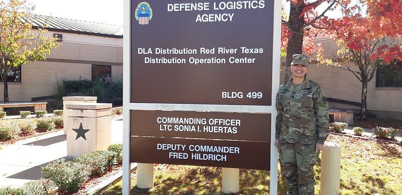 Lt. Col. Sonia I. Huertas stands next to the sign out front of Defense Logistics Agency-Red River Army Depot, displaying the names of the command staff. Upon seeing this sign for the first time with her name on it, she says, "It felt like I had arrived." (Staff photo by Junius Stone)