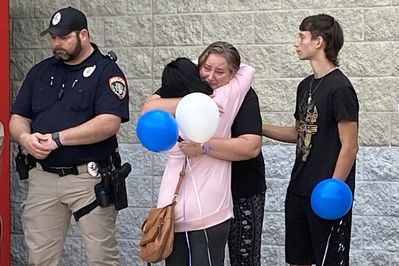 Participants embrace at a gathering in memory of Correctional Officer Lisa Mauldin on Friday, a day before the fifth anniversary of Mauldin's murder, at the Miller County jail in Texarkana, Arkansas. (Staff photo by Lynn LaRowe)