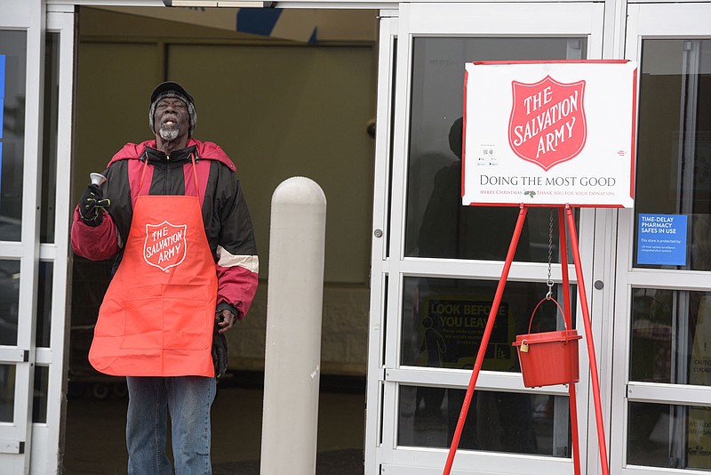 Robert Hall, a volunteer for the Salvation Army, rings a bell on Friday to help collect donations outside a Walmart in Fort Smith. Hall, who said he is in his 13th year of volunteering for the organization, sang &quot;I'll Be Home for Christmas&quot; while ringing the bell. Go to nwaonline.com/21121pDaily/ for today's photo gallery.
(NWA Democrat-Gazette/Hank Layton)