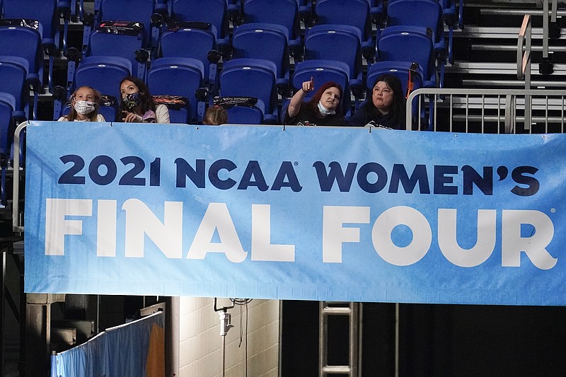 FILE - Fans watch from the stands during the first half of the championship game between Stanford and Arizona in the women's Final Four NCAA college basketball tournament in San Antonio, in this Sunday, April 4, 2021, file photo. The NCAA will pay basketball officials for the women's tournament the same amount it pays the officials for the men's competition. &#x201c;The national office continues to prioritize gender equity and has taken steps to correct the disparity of pay for officials selected to work the Division I Men&#x2019;s and Women&#x2019;s Basketball Championships,&#x201d; the NCAA said in a statement.  (AP Photo/Eric Gay, File)