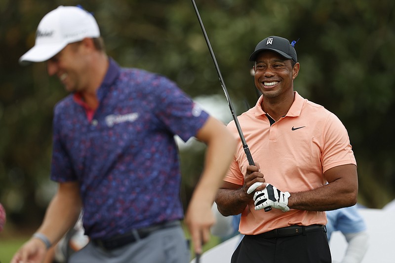 Tiger Woods, right, laughs with Justin Thomas on the 17th tee during the first round of the PNC Championship golf tournament Saturday, Dec. 18, 2021, in Orlando, Fla. (AP Photo/Scott Audette)