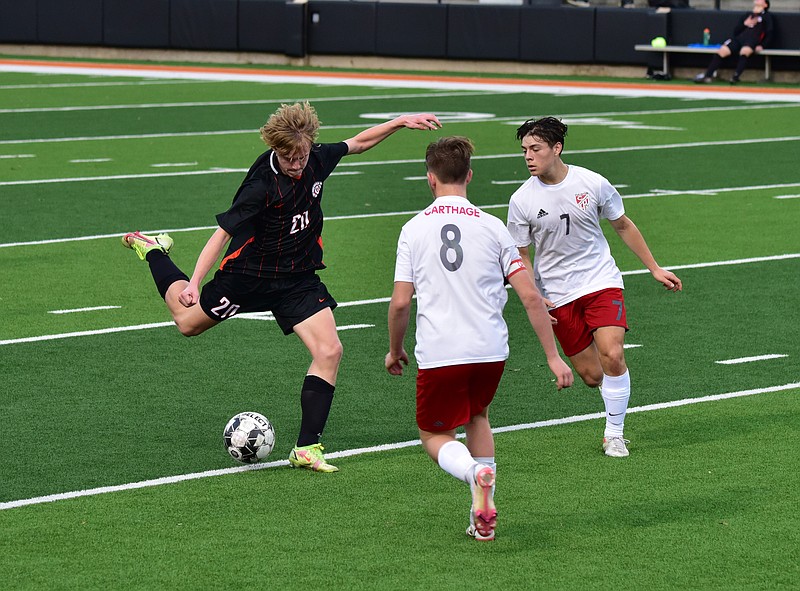 Texas High's Frank Delk, an attacking midfielder, unleashes a shot while two Carthage defenders close in. The Tigers defeated the Bulldogs 2-0 to improve to 2-0 on the season. (Photo courtesy of Richard Blake)