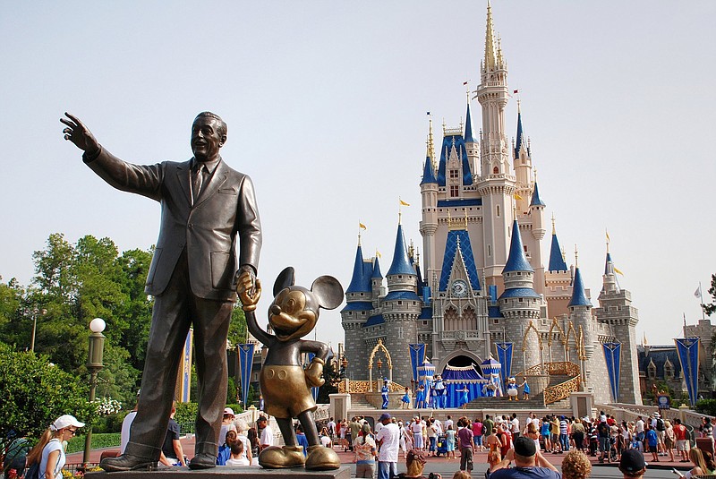 A statue of Walt Disney with Mickey Mouse stands outside the entrance to Cinderella’s Castle at Disney World in Orlando, Fla. (Dreamstime/TNS/Libo Tang)