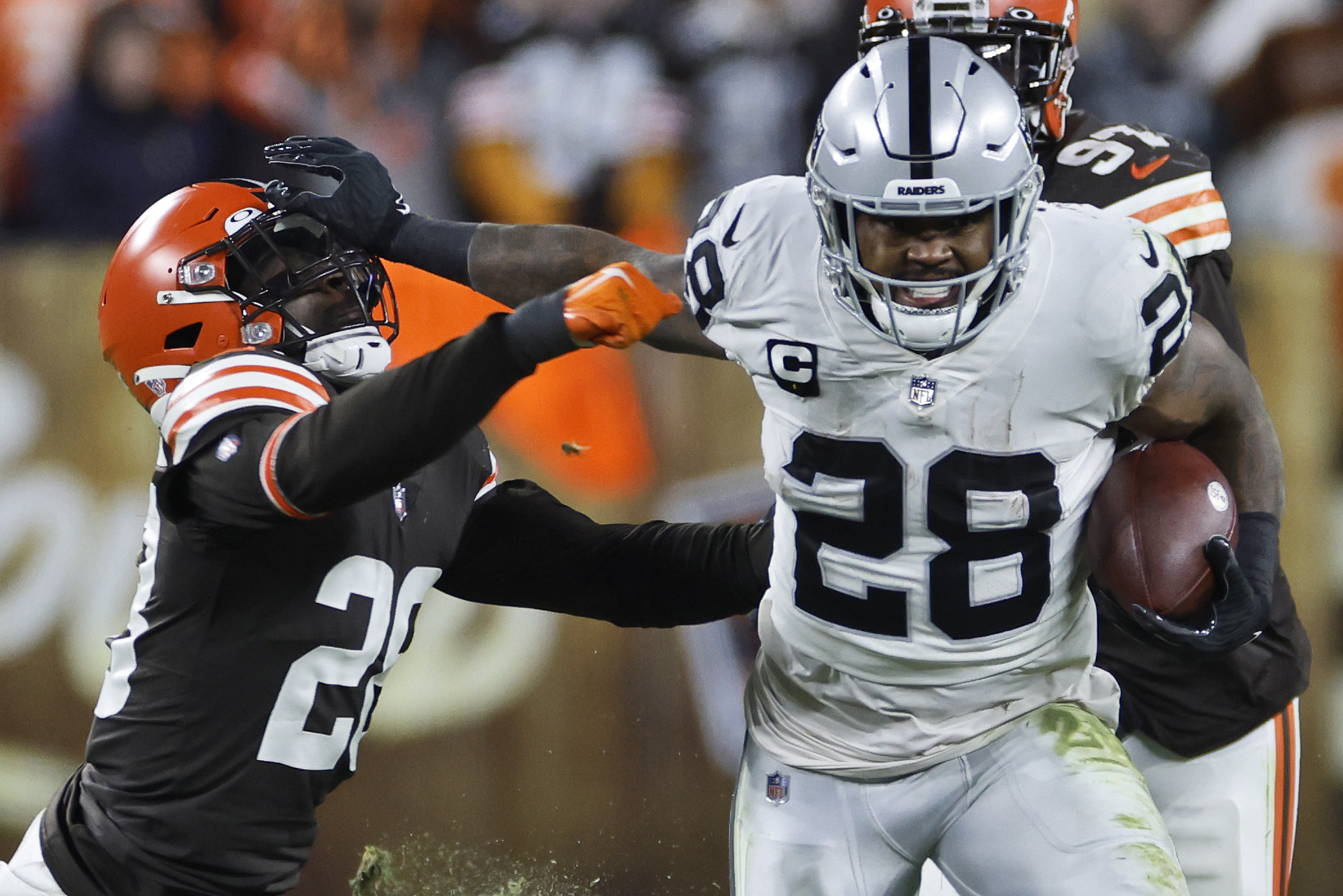 Raiders cornerback Keisean Nixon (22) and teammate quarterback Derek Carr  (4) walk off the fiel …