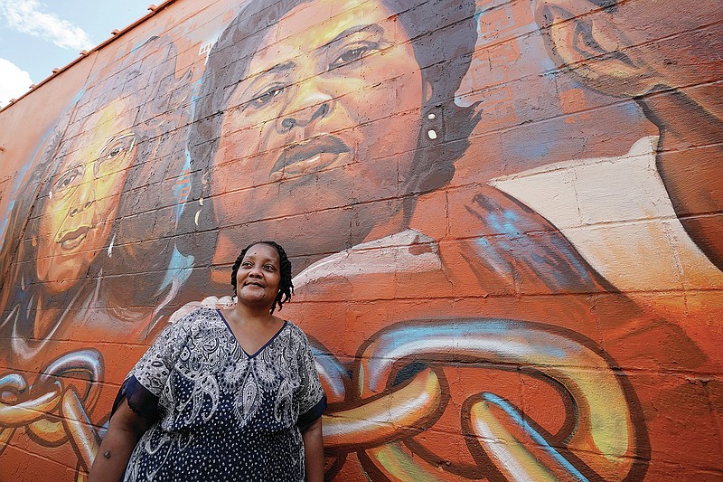 FILE - Jacqueline Hamer Flakes, the adoptive daughter of civil rights icon Fannie Lou Hamer, stands beneath the mural of her mother, that was painted on the side of the Council of Federated Organizations building in Jackson, Miss., on July 24, 2021.  A documentary about Mississippi Delta sharecropper and civil rights icon Fannie Lou Hamer will open the 10th season of the Emmy award-winning PBS series, America ReFramed. (AP Photo/Rogelio V. Solis, File)