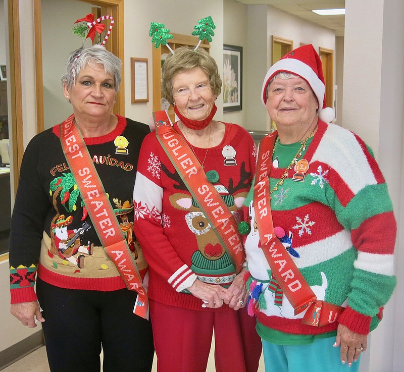 Westside Eagle Observer/SUSAN HOLLAND
Winners in the ugly sweater contest at Billy V. Hall Senior Activity Center display their sashes and badges Thursday, Dec. 16, as they wear their prize-winning sweaters. Pictured are first place winner LaVonda Augustine, second place winner Juanita Whiteside and third place winner Mary Griffin.