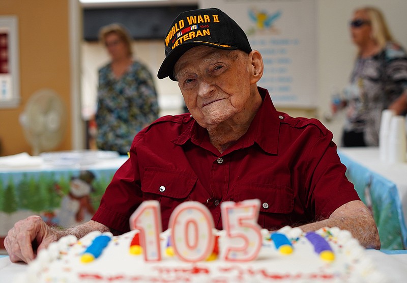 Navy World War 2 veteran William E. Monfort, who turned 105 on December 17 celebrates with members of his church on Sunday, Dec. 19, 2021 in Tampa. Monfort lived through the attack on Pearl Harbor and fighting in the Pacific during WWII as a member of the Navy. He recently survived a COVID-19 infection as well (during the summer of 2020, before vaccines were available).