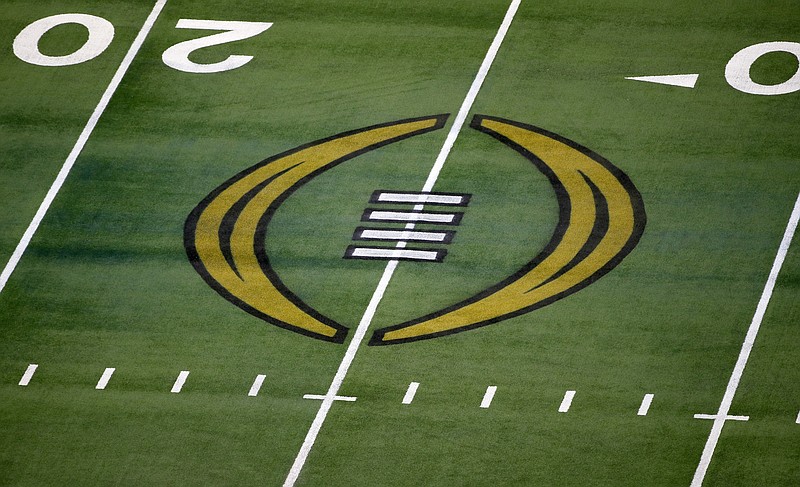 FILE - The College Football Playoff logo is shown on the field at AT&amp;T Stadium before the Rose Bowl NCAA college football game between Notre Dame and Alabama in Arlington, Texas, Jan. 1, 2021. If a team is unavailable to play in College Football Playoff semifinals on Dec. 31 because of COVID-19 issues, the game will be forfeited and the available team will advance to the championship game.  With COVID-19 cases spiking across the country due to the omicron variant, the CFP announced Wednesday, Dec. 22, contingency plans for the semifinals and national championship game, which is scheduled for Jan. 10 in Indianapolis. (AP Photo/Roger Steinman, File)