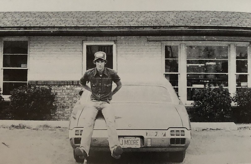 A high school friend of John Moore sits atop John’s 1972 Oldsmobile Cutlass Supreme. (Photo by John Moore, circa 1980)