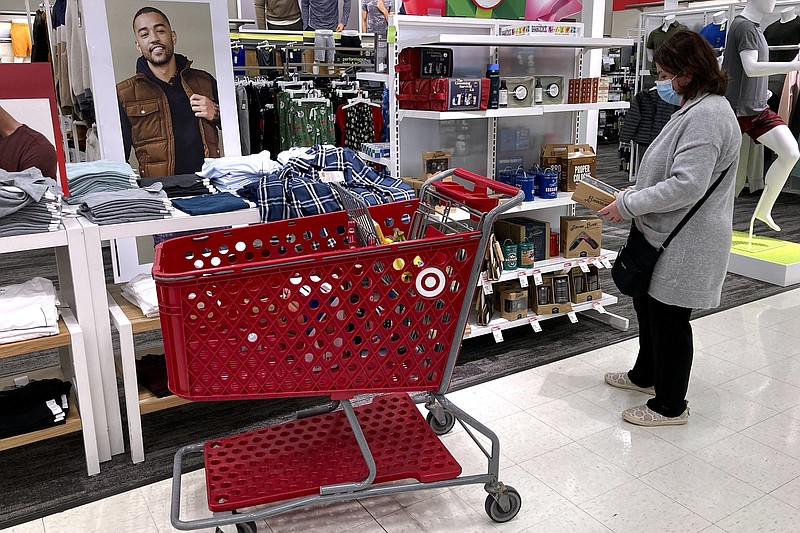 A shopper shops at a retail store in Niles, Ill., Saturday, Dec. 18, 2021. The National Retail federation, the nation's largest retail trade group, said this month that the holiday shopping season appears to be on pace to exceed its sales growth forecast of between 8.5% and 10.5% despite additional challenges this year, from a new variant of the coronavirus, to soaring inflation. (AP Photo/Nam Y. Huh)