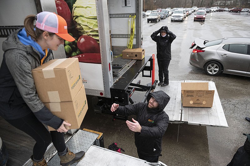 Northwest Arkansas Foodbank volunteers and workers distribute food at the Marvin?s IGA Parking Lot onS. School Ave. Friday Dec. 17, 2021 in Fayetteville.
Go to nwaonline.com/211225Daily/ to see more features photos. 
(NWA Democrat-Gazette/Spencer Tirey)