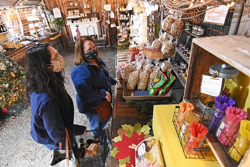 Megan Peters (left) and her mother, Jackie Peters, shop for stocking stuffers Friday morning at Me and McGee Market in North Little Rock.
(Arkansas Democrat-Gazette/Staci Vandagriff)