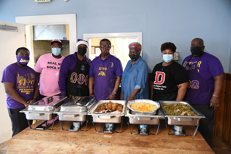 From left, Marcus Tatum, Robert Woodfork, Cleveland Gordon Jr., Steven Reaves, Darcell Preston, Tasha Hines and Tony Hines are shown with the meal they served to youths at Ouachita Children, Youth and Family Services on Christmas Day. - Photo by Tanner Newton of The Sentinel-Record