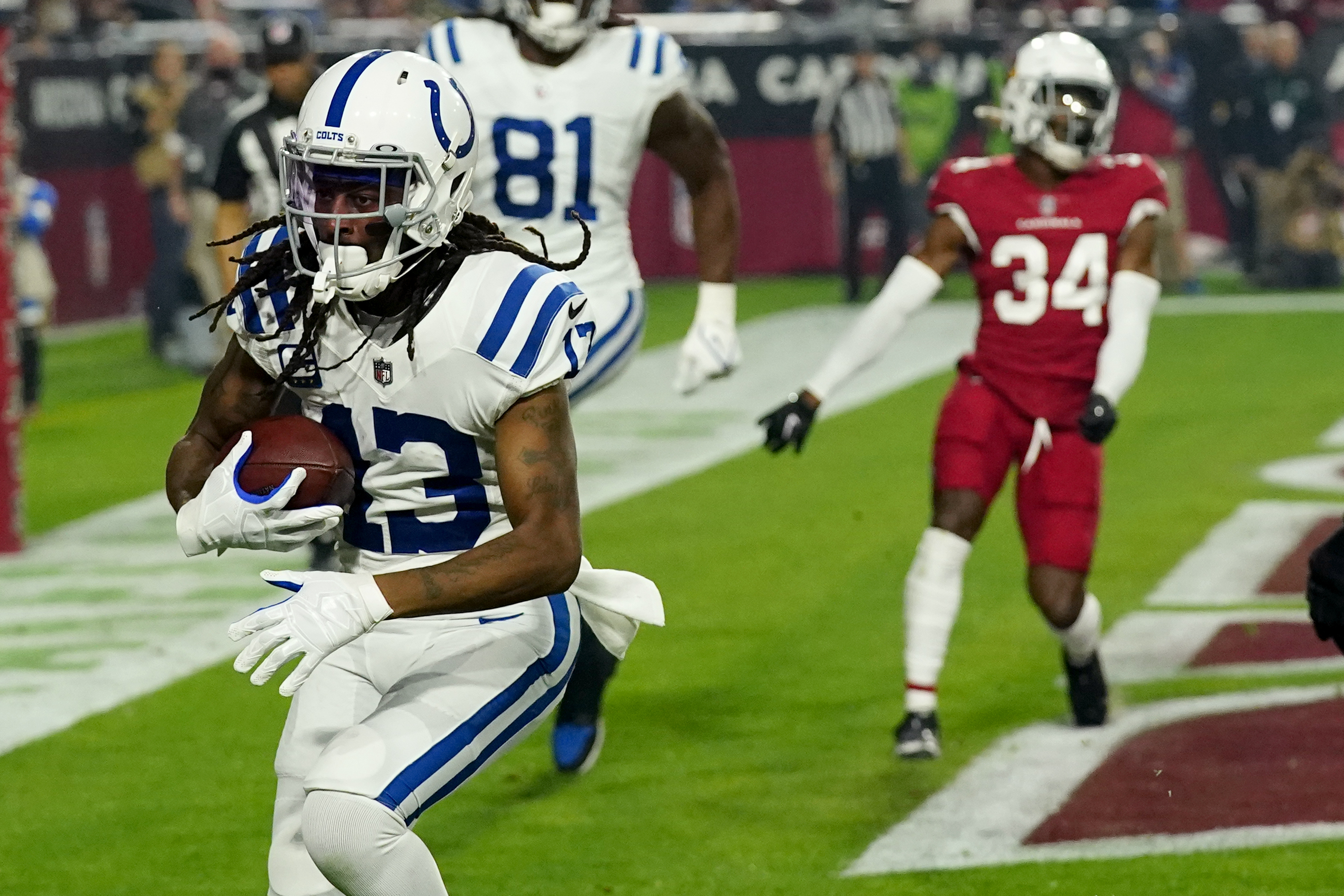 Michael Pittman of the Indianapolis Colts leaps over Marco Wilson