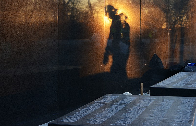 A wall with 43,000 names of the dead is being installed at the Korean War Veterans Memorial in Washington. The first seven-ton granite block with 450 names was placed early Monday. MUST CREDIT: Photo for The Washington Post by Astrid Riecken