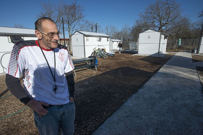 Craig Kritzer talks Wednesday Dec. 21, 2021 about living at New Beginnings microshelter community in Fayetteville. New Beginnings is a community with residents who experienced homelessness living in 20 prefabricated homes. The community opened in September, and residents come up with their own community rules while getting assistance to become self-sustaining. Kritzer has been a resident at New Beginnings since September. Visit nwaonline.com/2112126Daily/  (NWA Democrat-Gazette/J.T. Wampler)