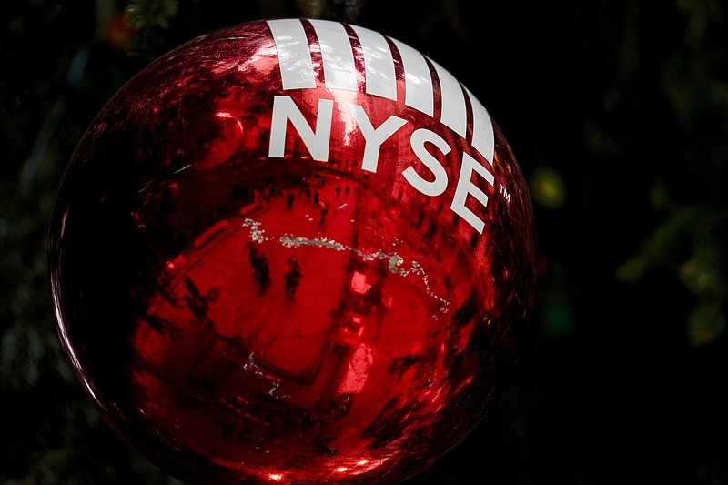 FILE - An oversized ornament is hung from a giant Christmas tree erected outside the New York Stock Exchange, Tuesday, Nov. 30, 2021, in New York. (AP Photo/John Minchillo, File)