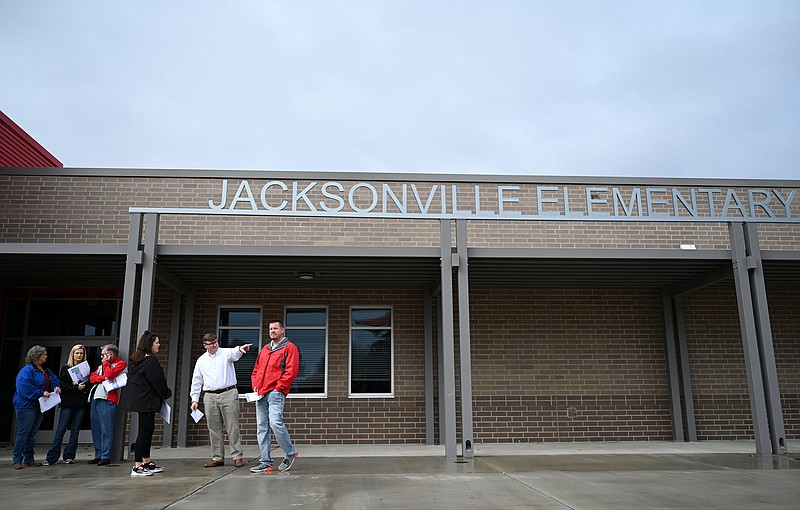 Members of the Jacksonville North Pulaski County School Board look at the drop-off area outside the new Jacksonville Elementary School during a tour of the building on Tuesday, Dec. 14, 2021. Students will start in the new building in January.

(Arkansas Democrat-Gazette/Stephen Swofford)