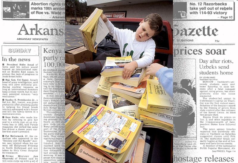 The Jan. 19, 1992, Arkansas Democrat-Gazette published a photo of Conley Hallmark, 7, grappling with 1991 phone directories. His Just Do It 4-H Club gathered 300 old phone books from 20 Twin City Bank locations and delivered them to a ReDirectory collection bin at a Harvest Foods store in Maumelle. (Democrat-Gazette file photo)
