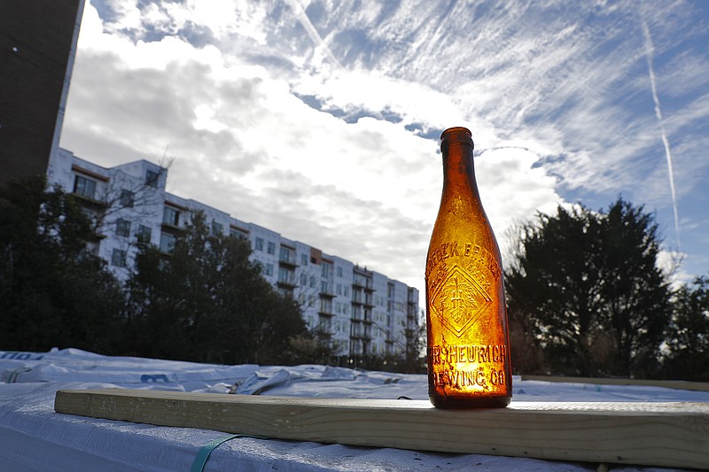 A Heurich beer bottle is seen in front of luxury lofts being built in downtown Norfolk, Virginia, Friday morning Dec. 17, 2021. While constructing the luxury lofts apartments along the water, Breeden Construction crews came across decades-old artifacts, including the Heurich beer bottle. (Jonathon Gruenke/The Virginian-Pilot/TNS)