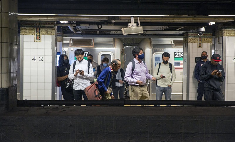 People in face masks wait for subway trains at Grand Central Terminal during the coronavirus pandemic in New York City on Monday, September 27, 2021. (AP Photo/Ted Shaffrey)