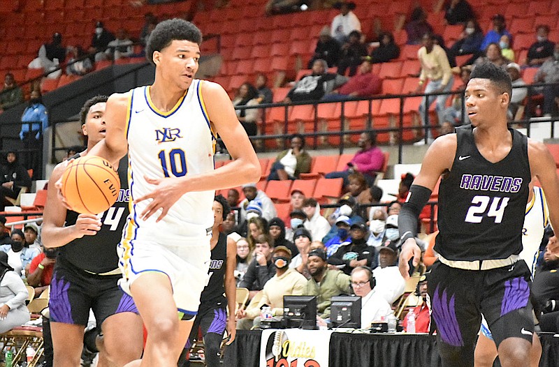 Kel'el Ware of North Little Rock drives past Brandon Miller of Cane Ridge for a dunk in the third quarter Tuesday, Dec. 28, 2021, at the Pine Bluff Convention Center. (Pine Bluff Commercial/I.C. Murrell)