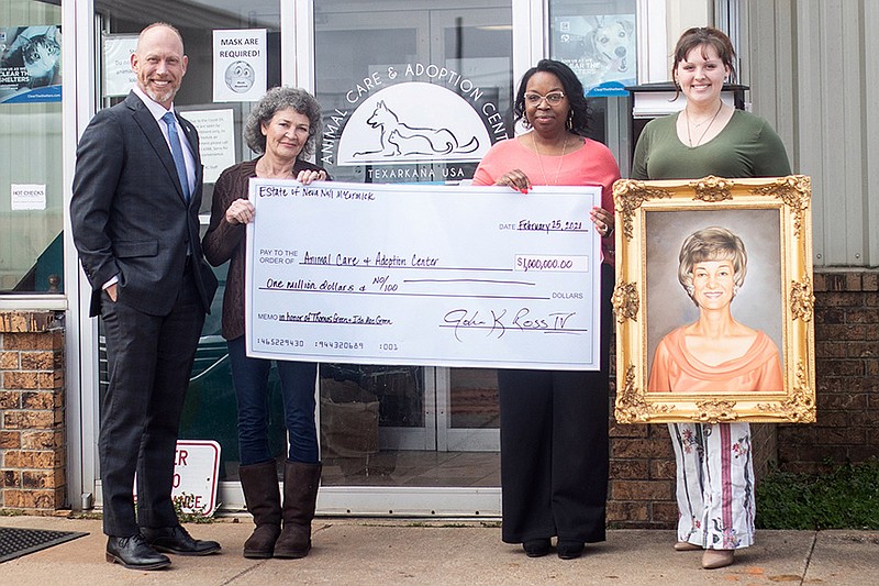 In this Feb. 25, 2021, file photo, representatives of the Neva Nell McCormick Trust present a ceremonial check to Texarkana, Arkansas, city staff and display a portrait of McCormick, who left $1 million to the Animal Care and Adoption Center. (Staff file photo by Kelsi Brinkmeyer)