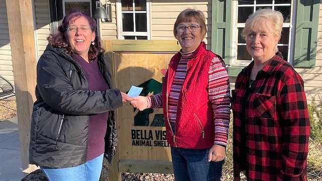 Photo Submitted Julia Doverspike, left, and Shari Ogburn of the Bella Vista 9 Hole Golf League present a $321 donation to the Bella Vista Animal Shelter, Nancy Culins. Money was collected at the golf league's Member Guest end of year luncheon.