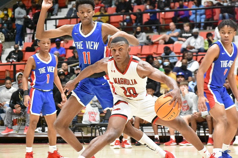 Derrian Ford of Magnolia spins around Dallas Thomas of Little Rock Parkview in the championship round of the King Cotton Classic Creed Bracket on Wednesday, Dec. 29, 2021, at the Pine Bluff Convention Center. (Pine Bluff Commercial/I.C. Murrell)