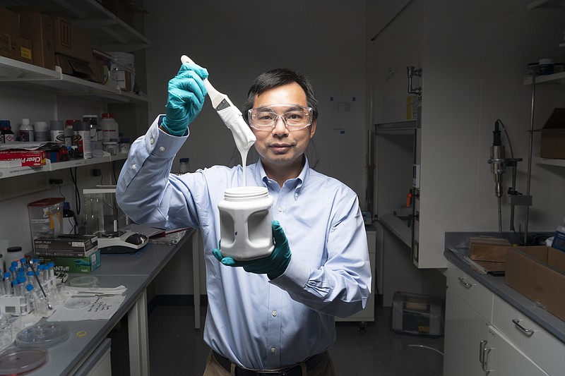 This photo provided by John Underwood shows Purdue University professor Xiulin Ruan on Aug. 25, 2021, at his laboratory in West Lafayette, Ind., with a brush full of what&#x2019;s considered the world&#x2019;s whitest paint. Ruan, a professor of mechanical engineering at Purdue, and his graduate students began working on the paint project seven years ago. The resulting highly reflective paint recently earned the title of the world&#x2019;s whitest paint in the Guinness World Records book. The paint is considered a breakthrough in sustainability that could reduce or even eliminate the need for air conditioning. (John Underwood via AP)