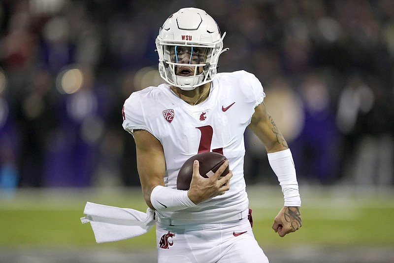 FILE -  Washington State quarterback Jayden de Laura runs the ball on a keeper play against Washington during the second half of an NCAA college football game, on Nov. 26, 2021, in Seattle. Washington State faces Central Michigan in the Sun Bowl. (AP Photo/Ted S. Warren, File)
