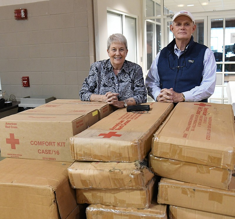 Sally Carder, left, volunteer outreach coordinator for St. Luke's, and Larry Barnes, director of operations at First United Methodist Church, stand next to the 40 cots and 60 blankets that the American Red Cross donated to help with the homeless at FUMC. - Photo by Tanner Newton of The Sentinel-Record
