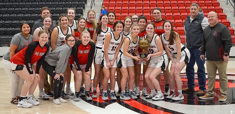 Lady Blackhawks won the championship of the Pea Ridge Holiday Tournament last week defeating Horatio 65-44 on Tuesday, Star City 44-40 on Wednesday and Mammoth Springs 54-45 on Thursday. Sponsor of the tournament was C.R. Crawford. Owner Scott Stokenbury presented the trophy to the team.