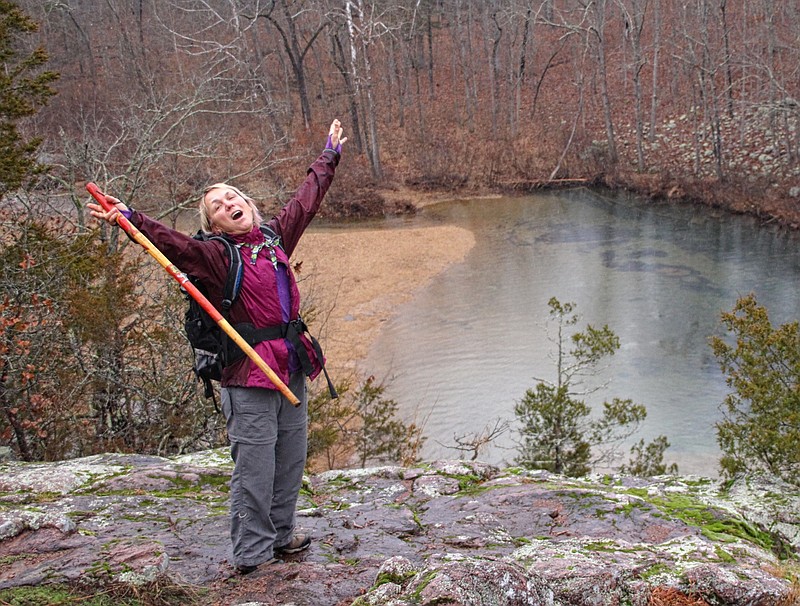 Dalene Ketcher rejoices above a blue hole pool along the Current River, one of several such pools hikers find along the Trans-Ozark Trail.  (Special to the Democrat-Gazette/Bob Robinson)