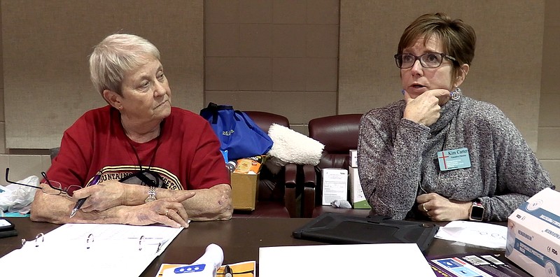 Sally Carder, left, volunteer outreach coordinator for St. Luke’s Episcopal Church, and Kim Carter, executive director of Cooperative Christian Ministries and Clinic, speak to The Sentinel-Record about the decision to extend the hours of a warming shelter Monday night and plans for another warming shelter to open later in the week. - Photo by Donald Cross of The Sentinel-Record