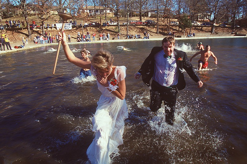 Mandy Ware and her brother Jordan Abbott run from chilly water with other competitors Jan. 12, 2002, in a Polar Bear Plunge for Special Olympics at Lakewood in North Little Rock. (Democrat-Gazette file photo)