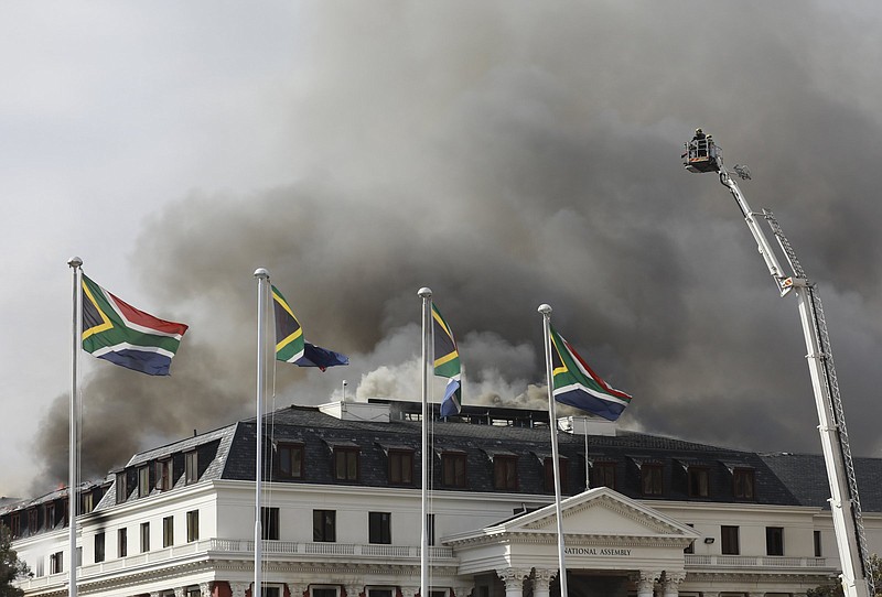 Smoke rises from the Parliament in Cape Town, South Africa, Monday, Jan 3, 2022 after the fire re-ignited late afternoon. Firefighters are again on the scene after a major blaze tore through the precinct a day earlier. (AP Photo/Nardus Engelbrecht)