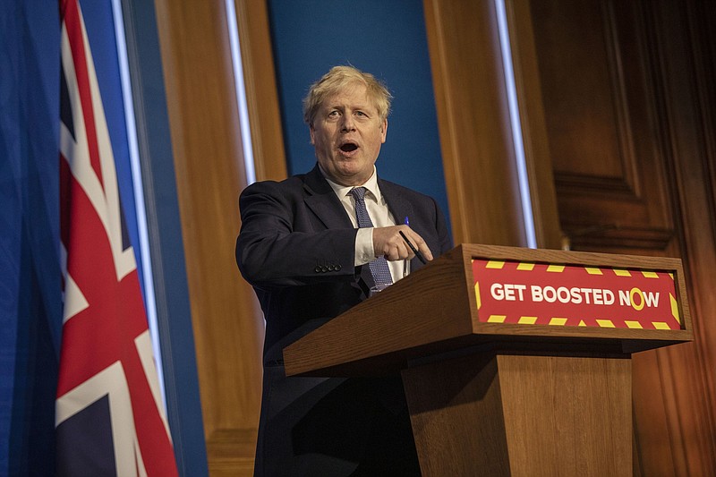 Britain's Prime Minister Boris Johnson gestures during a  coronavirus media briefing in Downing Street, London, Tuesday, Jan. 4, 2022.  Johnson sees no need for further restrictions to curb the spread of the coronavirus' omicron variant, his spokesman said ahead of a press conference on Tuesday. Amid indications that omicron may produce ?milder? illness than earlier variants and the success of a nationwide vaccine booster program, the government believes the existing level of controls is still appropriate. (Jack Hill, Pool Photo via AP)