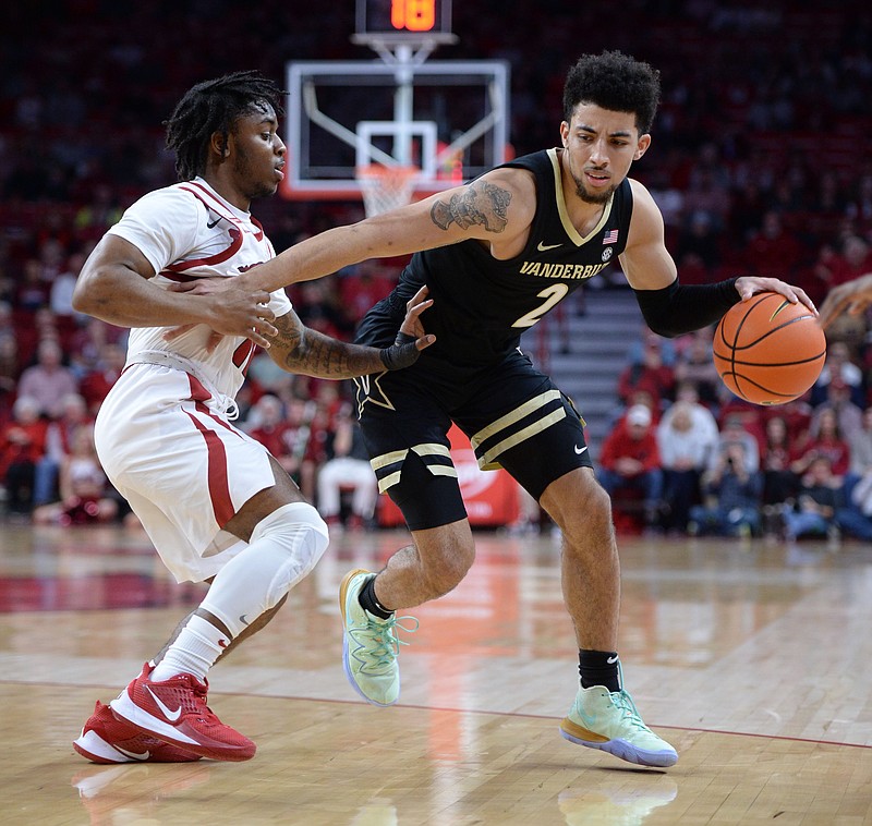 Arkansas guard Chris Lykes, left, defends as Vanderbilt guard Scotty Pippen Jr. drives with the ball during the first half of Tuesday's game in Bud Walton Arena in Fayetteville. The Commodores held on to down the Razorbacks 75-74 after JD Notae missed a 3-pointer at the buzzer. - Photo by Andy Shupe of NWA Democrat-Gazette