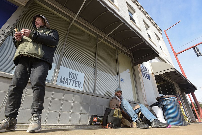 John Beasley (left) and Terry Manns visit with each other on Thursday, Jan. 6, 2022, outside The Next Step, a homeless shelter and day room in Fort Smith. The city's Board of Directors recently heard public opinions about whether to rezone a property at 1400 U Street South to allow for the expansion of Next Step, which currently operates at 123 North Sixth Street. Visit nwaonline.com/220109Daily/ for today's photo gallery.
(NWA Democrat-Gazette/Hank Layton)