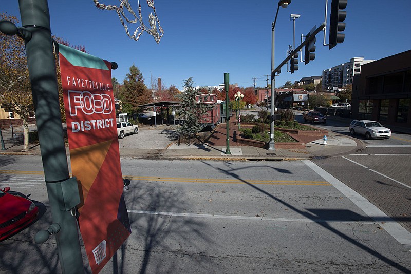 The northwest corner of West Avenue and Dickson Street in Fayetteville is seen Nov. 11, 2021, the site of a planned parking deck. (File photo/NWA Democrat-Gazette/J.T. Wampler)