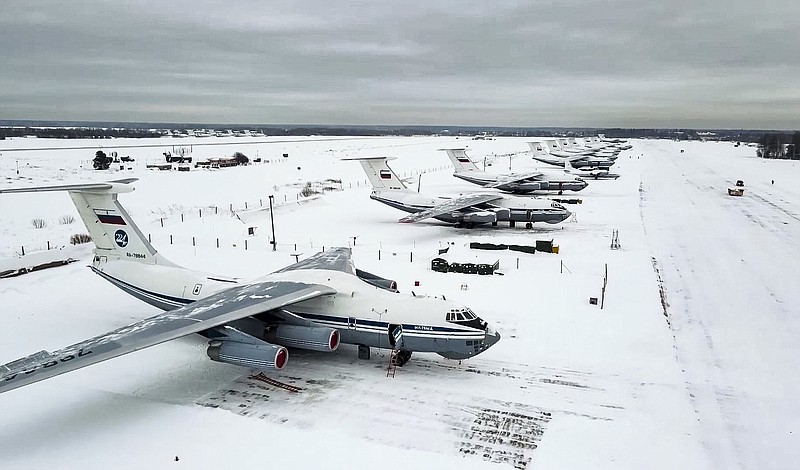 In this image taken from footage provided by the RU-RTR Russian television, Russian military planes parked  at an airfield in Russia, Friday, Jan. 7, 2022. Over 70 cargo planes are being deployed in Russia's peacekeeping mission in Kazakhstan according to the Defense Ministry chief spokesman's briefing on Friday, after the worst street protests since the country gained independence three decades ago. The demonstrations began over a near-doubling of prices for a type of vehicle fuel and quickly spread across the country, reflecting wider discontent over the rule of the same party since independence.  (RU-RTR Russian Television via AP)