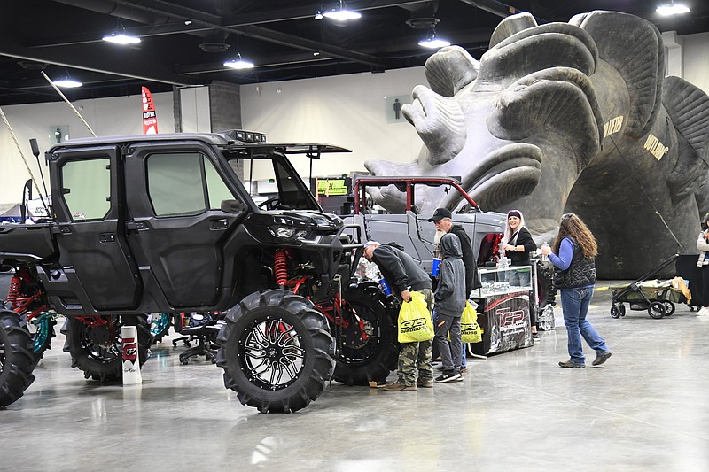 Attendees at the Offroad Products Expo look at side-by-sides at the Hot Springs Convention Center on Saturday. - Photo by Tanner Newton of The Sentinel-Record